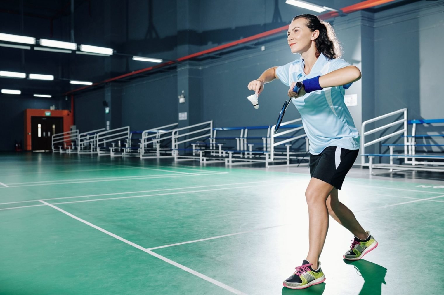 Woman playing badminton on courts
